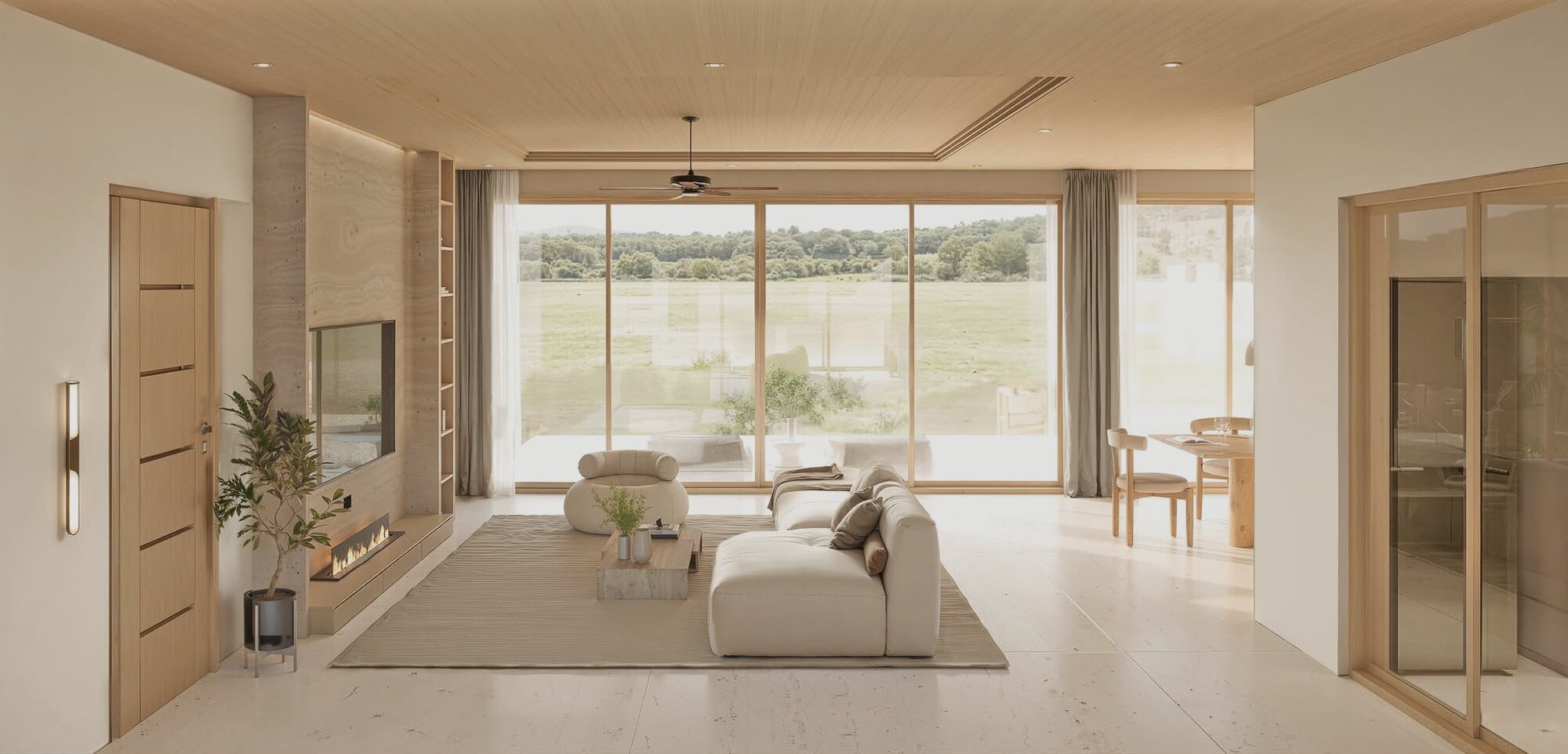Living area of an Alaya villa, warm timber and full-height glazing